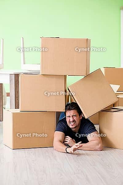 Man moving house with boxes [IBR125094367]