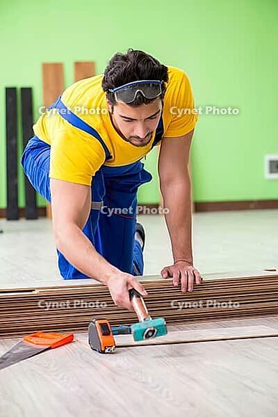 Professional contractor laying flooring at home [IBR125094376]