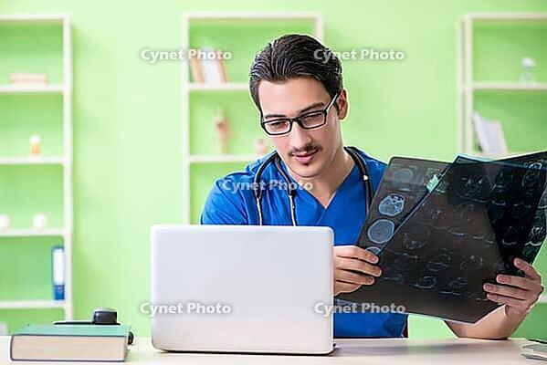 Young doctor working in the hospital [IBR125094377]