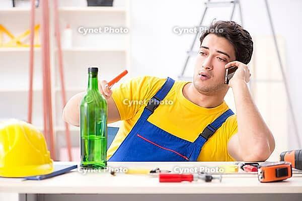 Drunk engineer working in the workshop [IBR125094378]