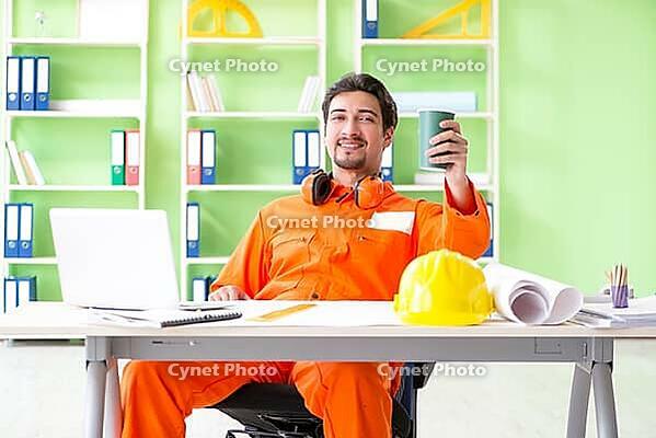 Construction supervisor planning new project in office [IBR125094380]