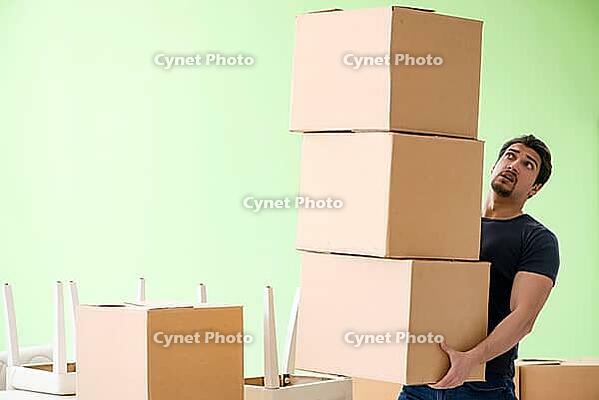 Man moving house with boxes [IBR125094383]