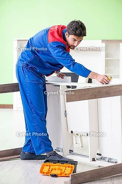 Repair contractor repairing broken furniture at home [IBR125094387]