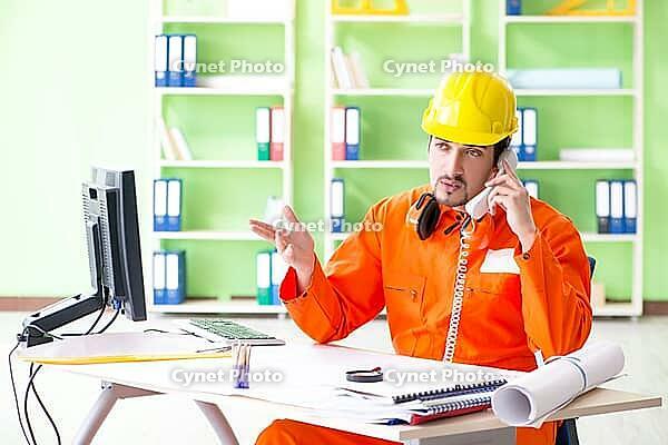 Construction supervisor planning new project in office [IBR125094389]