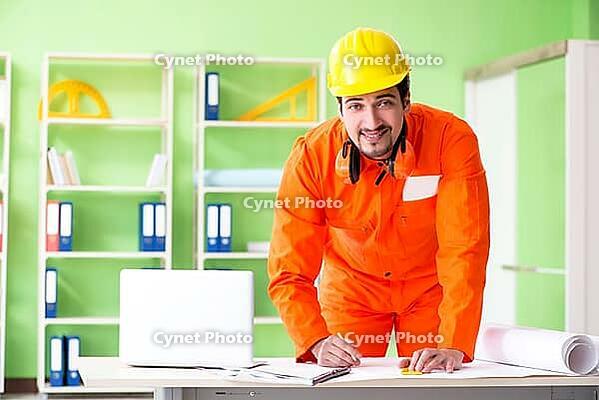 Construction supervisor planning new project in office [IBR125094390]