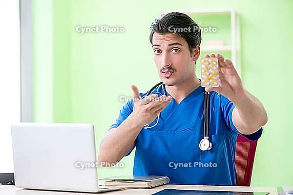 Young doctor working in the hospital [IBR125094397]