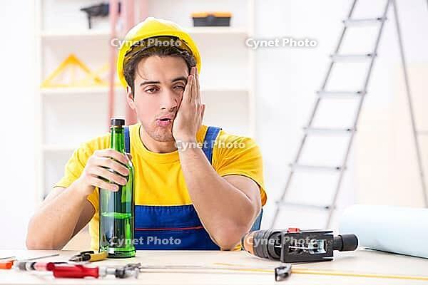 Drunk engineer working in the workshop [IBR125094402]