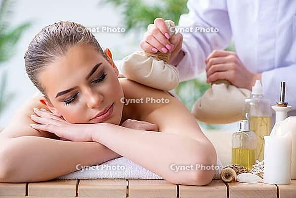 Woman during massage session in spa [IBR125094420]
