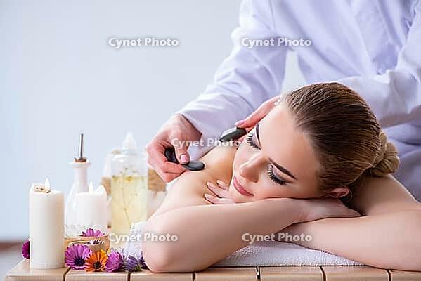 Woman during massage session in spa [IBR125094421]