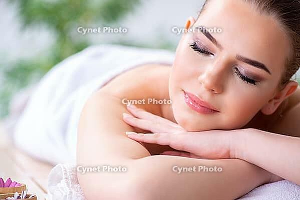 Woman during massage session in spa [IBR125094432]
