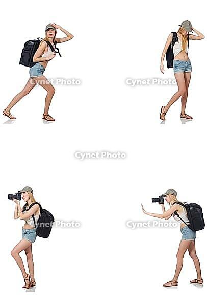 Beautiful woman in shorts with backpack and camera [IBR125117979]