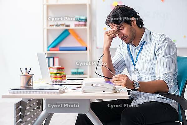 Young handsome male designer working in the office [IBR125117996]