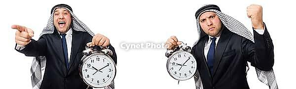 Arab businessman with alarm-clock in time management concept [IBR125118004]