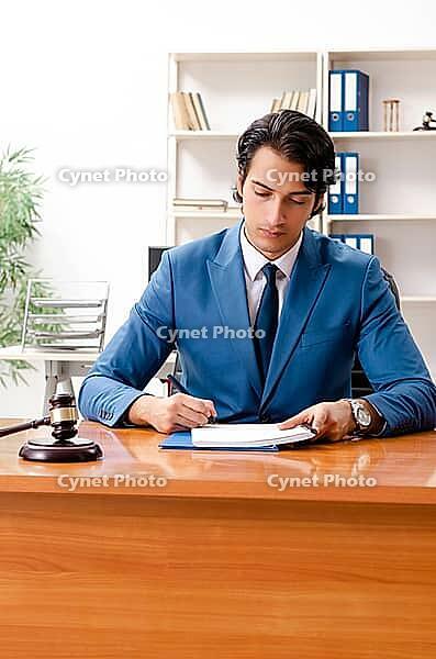 Young handsome judge sitting in courtroom [IBR125118016]