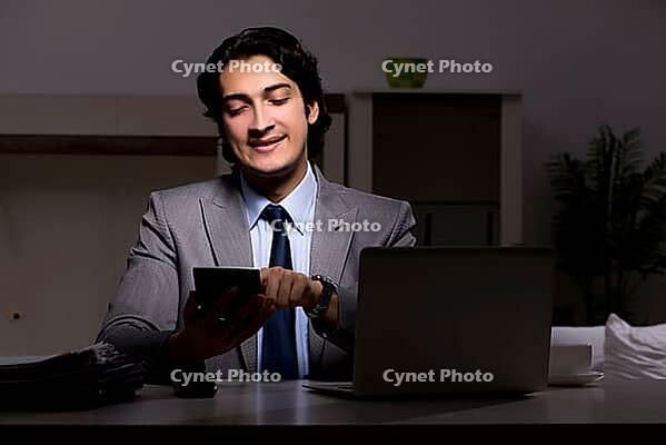 Young handsome employee and too much work in the office [IBR125118027]