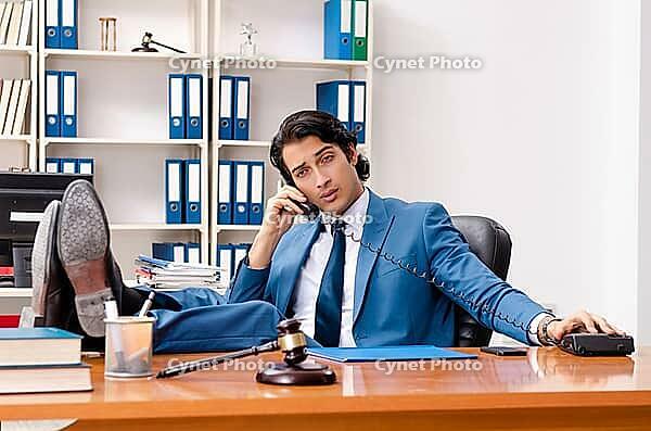 Young handsome judge sitting in courtroom [IBR125118032]