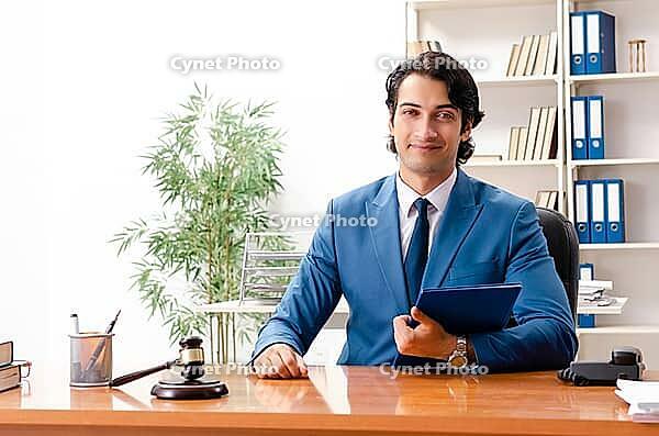 Young handsome judge sitting in courtroom [IBR125118042]