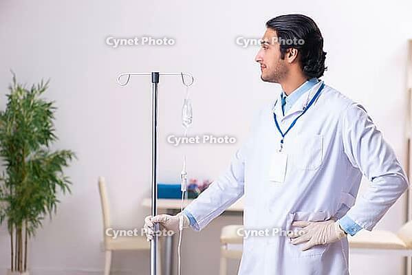 Young male doctor in blood transfusion concept [IBR125118044]