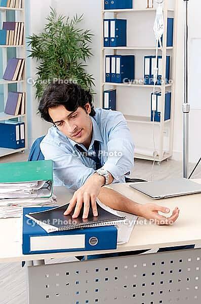 Young male employee in blood transfusion concept [IBR125118045]