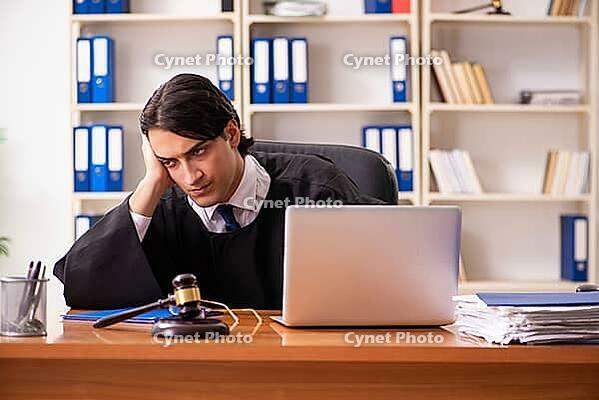 Young handsome judge working in court [IBR125118051]