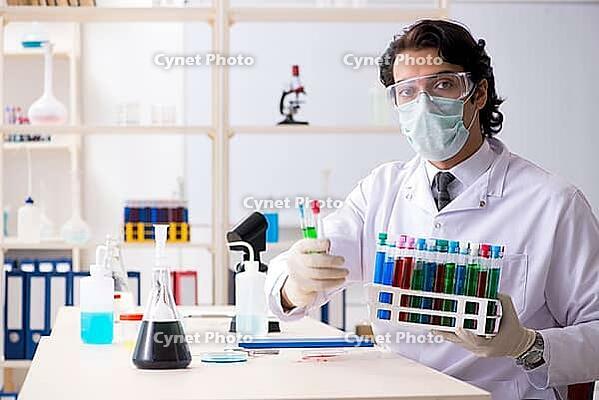 Young handsome chemist working in the lab [IBR125118052]