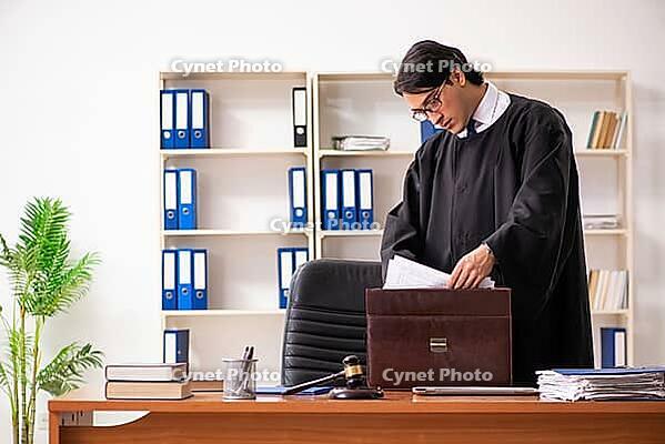 Young handsome judge working in court [IBR125118056]