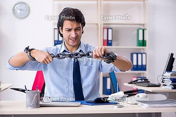 Young male businessman employee unhappy with excessive work [IBR125141678]