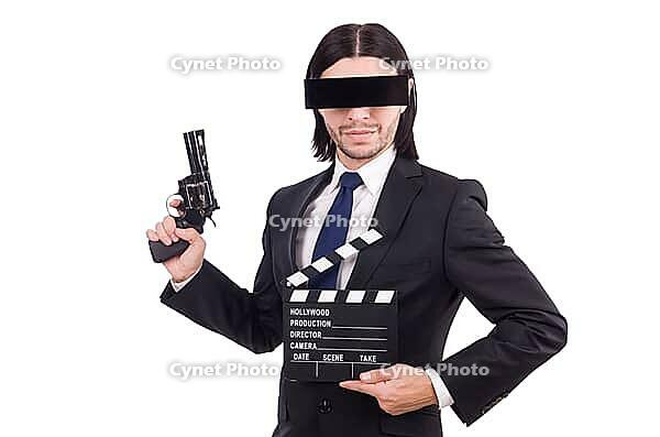 Man with movie board on white [IBR125141683]