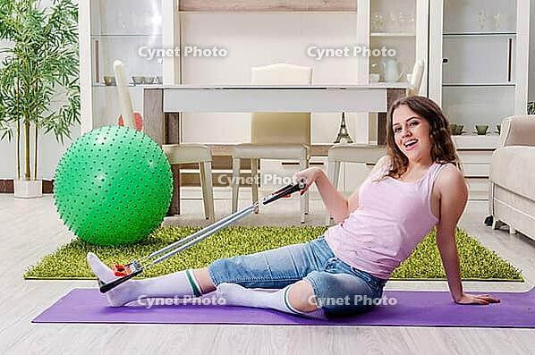 Young beautiful woman doing exercises at home [IBR125141686]
