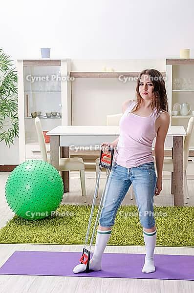 Young beautiful woman doing exercises at home [IBR125141687]
