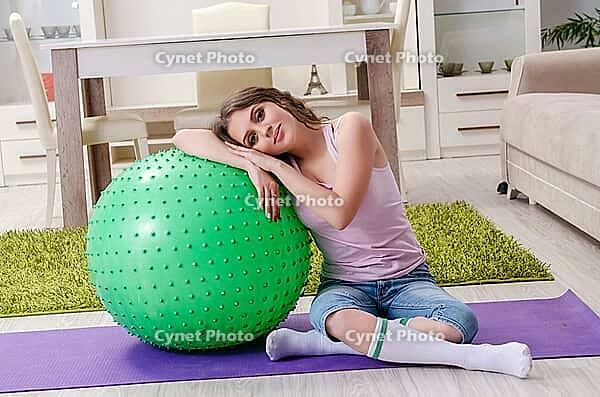 Young beautiful woman doing exercises at home [IBR125141689]