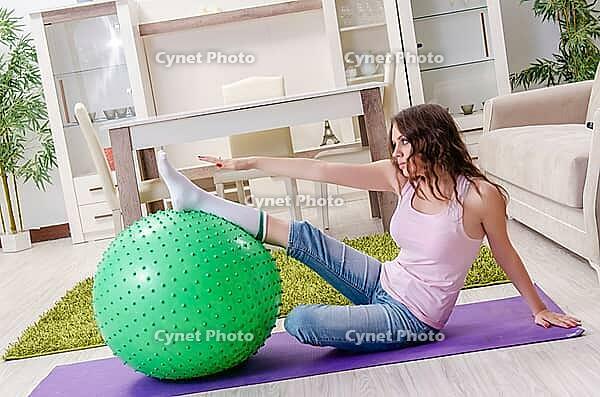 Young beautiful woman doing exercises at home [IBR125141690]