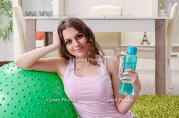 Young beautiful woman doing exercises at home [IBR125141694]