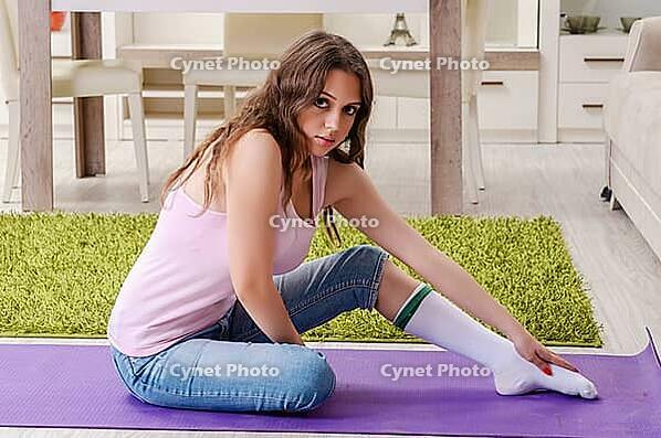 Young beautiful woman doing exercises at home [IBR125141711]