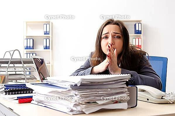 Young female employee unhappy with excessive work [IBR125141716]