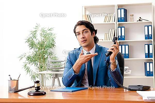 Young handsome judge sitting in courtroom [IBR125141724]