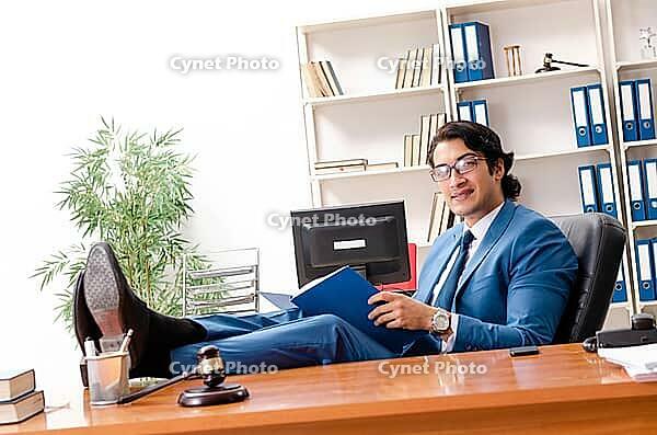 Young handsome judge sitting in courtroom [IBR125141725]