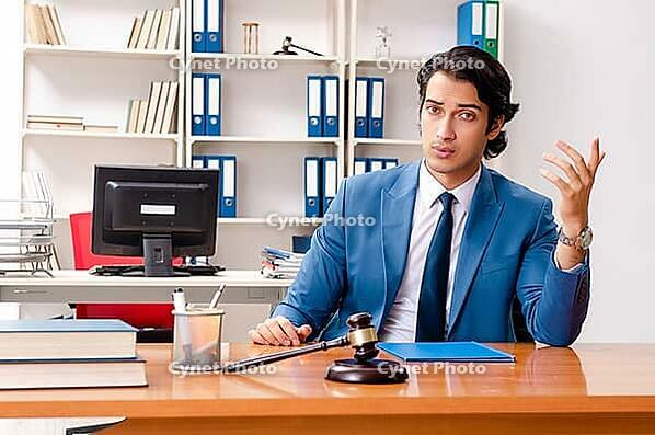 Young handsome judge sitting in courtroom [IBR125141727]
