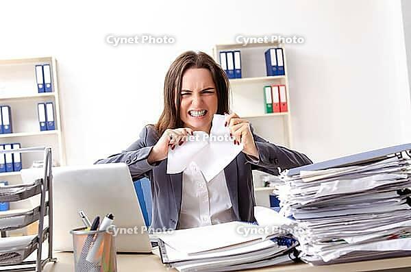 Young female employee unhappy with excessive work [IBR125141729]