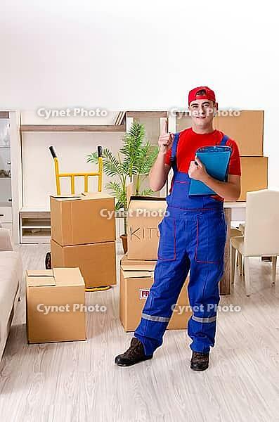 Young contractor with boxes working indoors [IBR125141733]