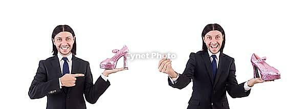 Man with woman shoes isolated on white [IBR125141742]