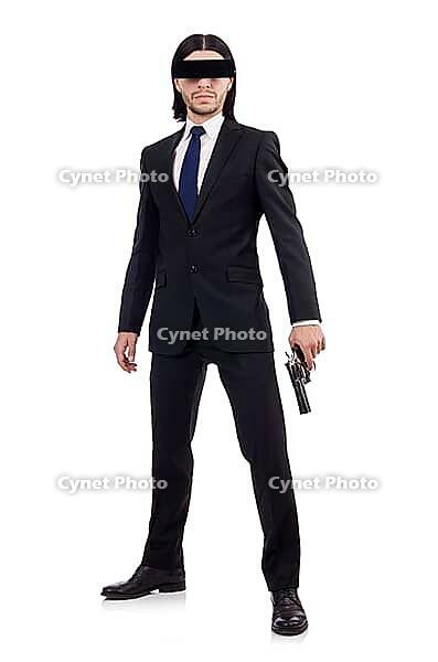 Young man with covered eyes and gun isolated on white [IBR125141743]