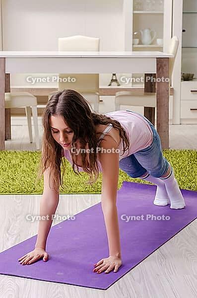 Young beautiful woman doing exercises at home [IBR125141744]