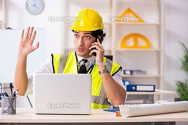 Male construction engineer working in the office [IBR125141764]