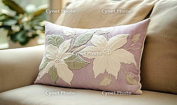 Soft lavender pillow with white poinsettia embroidery and hints of soft green. AI generated [IBR125167394]