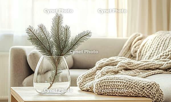Minimalist Christmas living room with a single white fir branch in a transparent glass vase on a wooden coffee table. AI generated [IBR125167429]