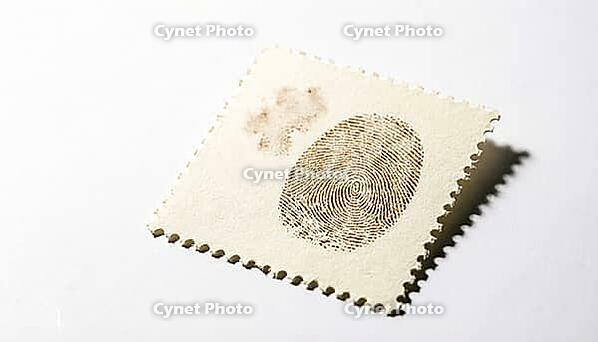Blank postage stamp with perforated edges, latent fingerprint friction ridges visible as sepia-tone developed print on stamp surface, forensic evidence collection concept, white background, studio shot, AI generated [IBR125167452]