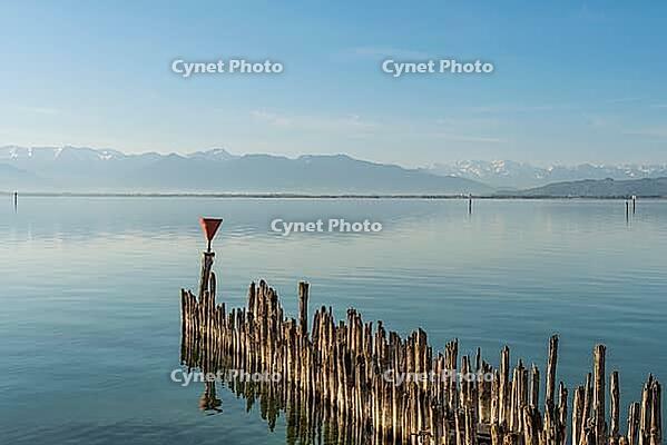 Wooden walkways on Lake Constance with a view of the Alps, moated castle, Bavaria, Germany [IBR125173446]