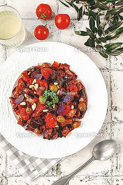 Sicilian caponata, vegetable stew, Italian cuisine, on a white plate, lifestyle, homemade dish, no people [IBR125177928]