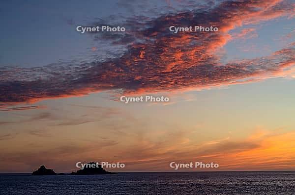 Sunset, sunset at sea, dramatic clouds, in the background rock formation The Brisons, Cot Valley Beach, Porth Nanven, coast, St Just in Penwith, Cornwall, England, Great Britain, Great Britain [IBR125177960]